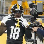 
              Pittsburgh Steelers wide receiver Diontae Johnson (18) mugs for the TV camera in the end zone after making a catch and then scoring a touchdown against the Baltimore Ravens during the second half of an NFL football game, Sunday, Dec. 5, 2021, in Pittsburgh. (AP Photo/Gene J. Puskar)
            