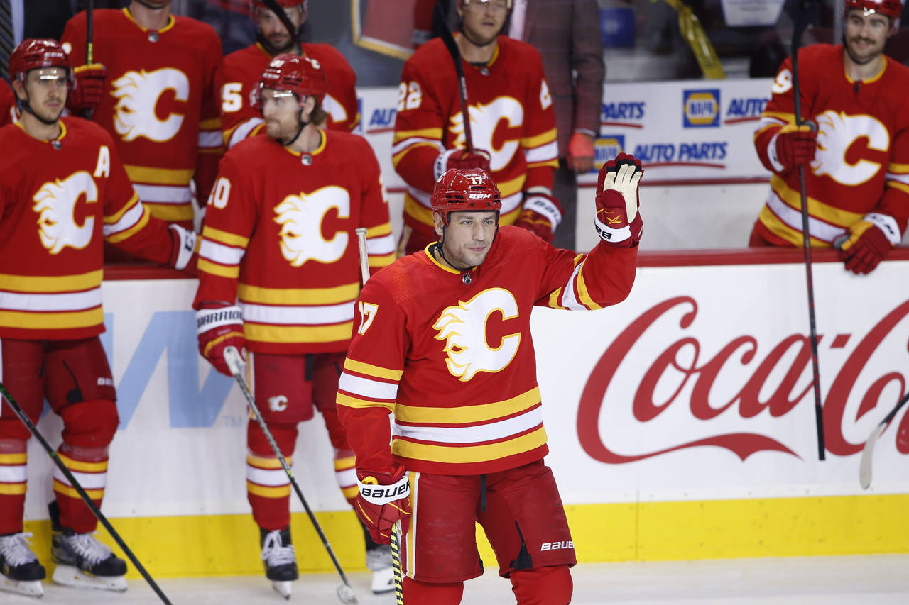 Calgary Flames' Milan Lucic acknowledges the crowd during a celebration of his having played in mor...