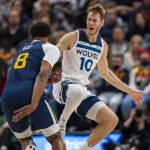 
              Minnesota Timberwolves forward Jake Layman (10) reacts as Utah Jazz forward Rudy Gay (8) dribbles behind his back during the first half of an NBA basketball game on Thursday, Dec. 23, 2021, in Salt Lake City. (AP Photo/Rick Egan)
            