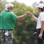 
              John Daly, left, fist bumps son John Daly II on the third green during the second round of the PNC Championship golf tournament Sunday, Dec. 19, 2021, in Orlando, Fla. (AP Photo/Scott Audette)
            