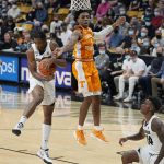 
              Colorado guard Keeshawn Barthelemy, left, pulls down a rebound as Tennessee guard Kennedy Chandler defends in the first half of an NCAA college basketball game Saturday, Dec. 4, 2021, in Boulder, Colo. (AP Photo/David Zalubowski)
            