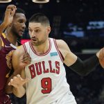 
              Chicago Bulls' Nikola Vucevic (9) drives against Cleveland Cavaliers' Evan Mobley (4) in the first half of an NBA basketball game, Wednesday, Dec. 8, 2021, in Cleveland. (AP Photo/Tony Dejak)
            