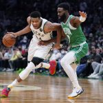 
              Milwaukee Bucks forward Giannis Antetokounmpo, left, drives to the basket against Boston Celtics guard Jaylen Brown, right, during the first half of an NBA basketball game, Monday, Dec. 13, 2021, in Boston. (AP Photo/Charles Krupa)
            