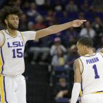 
              LSU guard Xavier Pinson (1) signals a three-point basket against Lipscomb next to center Efton Reid (15) during the first half an NCAA college basketball game in Baton Rouge, La., Wednesday, Dec. 22, 2021. (AP Photo/Matthew Hinton)
            