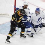 
              The puck goes wide as Tampa Bay Lightning's Pierre-Edouard Bellemare (41) defends against Boston Bruins' Patrice Bergeron (37) during the second period of an NHL hockey game, Saturday, Dec. 4, 2021, in Boston. (AP Photo/Michael Dwyer)
            