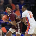
              Texas Southern forward John Walker III (24) is defended by Florida guard Phlandrous Fleming Jr. (24) during the first half of an NCAA college basketball game Monday, Dec. 6, 2021, in Gainesville, Fla. (AP Photo/Matt Stamey)
            