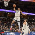 
              Memphis Grizzlies guard De'Anthony Melton (0) goes up for a dunk in the second half of an NBA basketball game against the Philadelphia 76ers, Monday, Dec. 13, 2021, in Memphis, Tenn. (AP Photo/Brandon Dill)
            