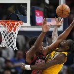 
              Indiana Pacers' Caris LeVert (22) is fouled by Chicago Bulls' Tyler Cook (25) as he goes up for a shot during the second half of an NBA basketball game, Friday, Dec. 31, 2021, in Indianapolis. (AP Photo/Darron Cummings)
            