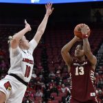 
              Boston College forward Taylor Soule (13) shoots over Louisville forward Ramani Parker (0) during the first half of an NCAA college basketball game in Louisville, Ky., Thursday, Dec. 30, 2021. (AP Photo/Timothy D. Easley)
            