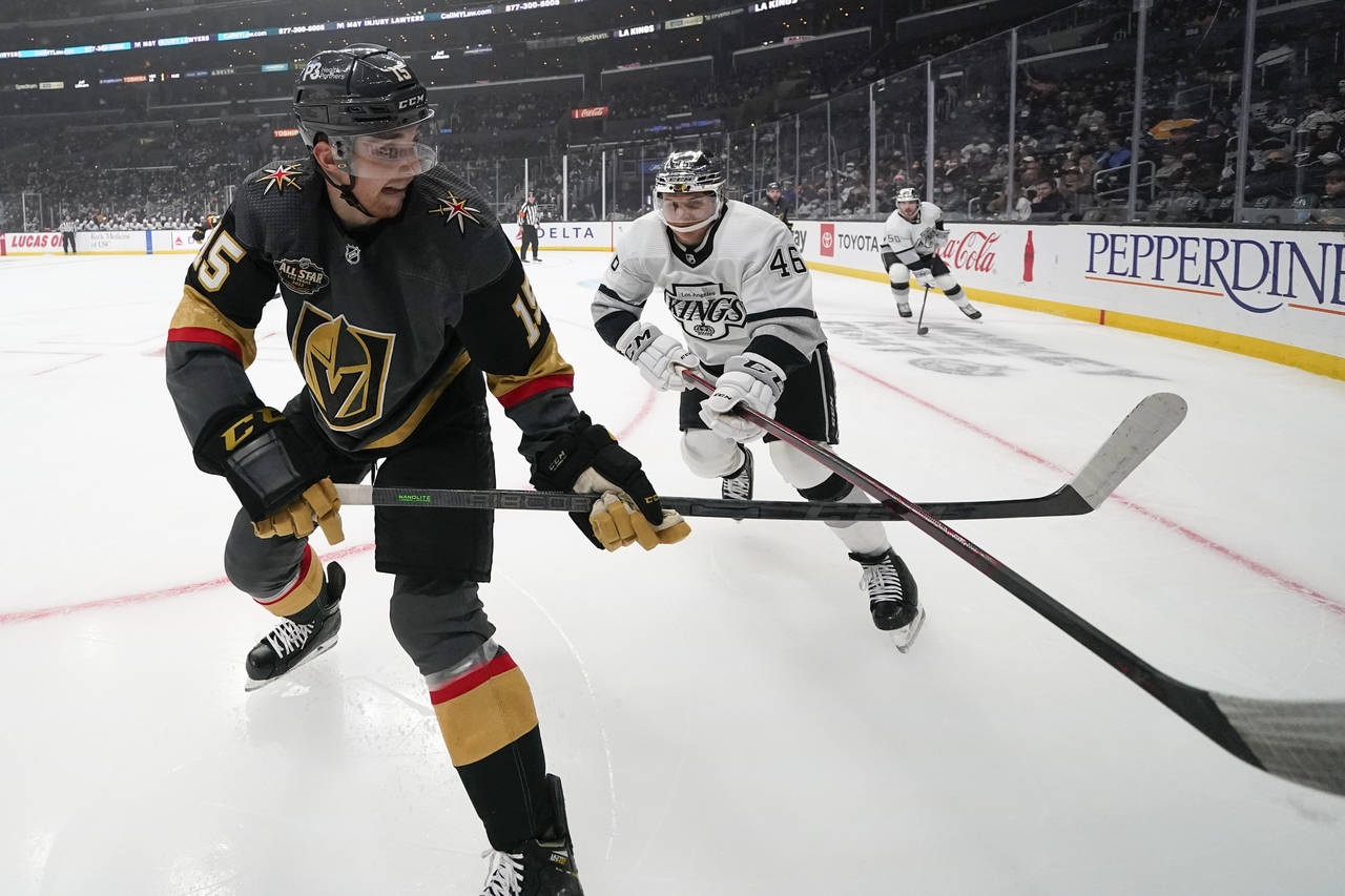 Vegas Golden Knights center Jake Leschyshyn (15) passes the puck under the stick of Los Angeles Kin...
