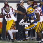
              Southern California wide receiver Kyle Ford (81) stiff-arms California safety Elijah Hicks (3) as he runs a pass reception in a for a touchdown during the second quarter of an NCAA college football game Saturday, Dec. 4, 2021, in Berkeley, Calif. (AP Photo/D. Ross Cameron)
            