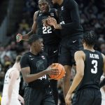 
              Michigan State center Mady Sissoko (22) and forward Marcus Bingham Jr. celebrate next to forward Gabe Brown (44) during the second half of an NCAA college basketball game against Oakland , Tuesday, Dec. 21, 2021, in Detroit. (AP Photo/Carlos Osorio)
            