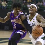 
              Baylor guard James Akinjo, right, is fouled by Northwestern State guard Brian White during the first half of an NCAA college basketball game Tuesday, Dec. 28, 2021, in Waco, Texas. (AP Photo/Rod Aydelotte)
            