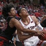 
              Arkansas State's Marquis Eaton (23) fouls Texas Tech's Kevin McCullar (15) during the first half of an NCAA college basketball game on Tuesday, Dec. 14, 2021, in Lubbock, Texas. (AP Photo/Brad Tollefson)
            