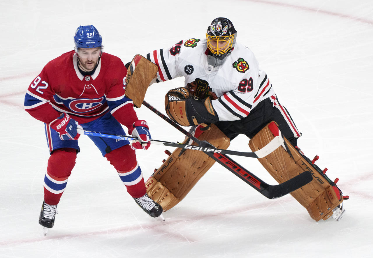 Chicago Blackhawks goaltender Marc-Andre Fleury fends off Montreal Canadiens' Jonathan Drouin after...