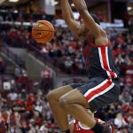 
              Ohio State forward Zed Key, top, dunks the ball in front of Wisconsin guard Jonathan Davis during the second half of an NCAA college basketball game in Columbus, Ohio, Saturday, Dec. 11, 2021. Ohio State won 73-55. (AP Photo/Paul Vernon)
            