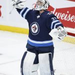 
              Winnipeg Jets goaltender Connor Hellebuyck (37) celebrates the team's win over the New Jersey Devils in an NHL hockey game Friday, Dec. 3, 2021, in Winnipeg, Manitoba. (John Woods/The Canadian Press via AP)
            