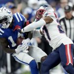 
              Indianapolis Colts wide receiver Zach Pascal (14) is knocked out of bounds by New England Patriots cornerback J.C. Jackson after catching a pass during the first half of an NFL football game Saturday, Dec. 18, 2021, in Indianapolis. (AP Photo/AJ Mast)
            