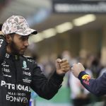 
              Mercedes driver Lewis Hamilton of Britain bumps fists with Red Bull driver Max Verstappen of the Netherlands after qualifying session for the Formula One Abu Dhabi Grand Prix in Abu Dhabi, United Arab Emirates, Saturday, Dec. 11, 2021. (AP Photo/Kamran Jebreili, Pool)
            