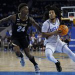 
              Colorado guard Elijah Parquet (24) defends against UCLA guard Tyger Campbell (10) during the second half of an NCAA college basketball game in Los Angeles, Wednesday, Dec. 1, 2021. (AP Photo/Ashley Landis)
            