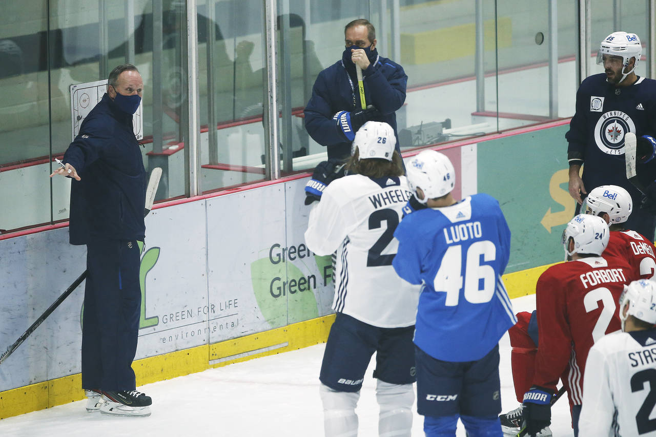 FILE - Winnipeg Jets assistant coach Dave Lowry, left, and head coach Paul Maurice talk to players ...