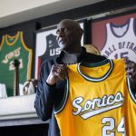 
              Former professional basketball player and Olympic gold medalist Spencer Haywood shows a Seattle SuperSonics jersey at his Las Vegas home Monday, Nov. 29, 2021. Haywood, the trailblazing forward who grew up picking cotton in Mississippi and wound up reshaping the league in a way that many take for granted today. (AP Photo/Ellen Schmidt)
            
