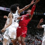 
              Louisville's El Ellis, right, shoots against Michigan State's Malik Hall, left rear, and Jaden Akins (3) during the first half of an NCAA college basketball game Wednesday, Dec. 1, 2021, in East Lansing, Mich. (AP Photo/Al Goldis)
            