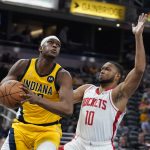 
              Indiana Pacers' Myles Turner (33) goes to the basket against Houston Rockets' Eric Gordon (10) during the second half of an NBA basketball game, Thursday, Dec. 23, 2021, in Indianapolis. (AP Photo/Darron Cummings)
            