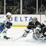 
              Los Angeles Kings goaltender Jonathan Quick, right, makes a save against Vancouver Canucks' Conor Garland during a shootout of an NHL hockey game Thursday, Dec. 30, 2021, in Los Angeles. The Kings won 2-1. (AP Photo/Jae C. Hong)
            