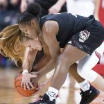 
              Indiana's Nicole Cardano-Hillary, in white uniform, and North Carolina State's Diamond Johnson vie for a loose ball during the second half of an NCAA college basketball game Thursday, Dec. 2, 2021, in Bloomington, Ind. (Darron Cummings)
            