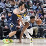
              Minnesota Timberwolves guard Malik Beasley, right, drives past Denver Nuggets guard Facundo Campazzo in the first half of an NBA basketball game Wednesday, Dec. 15, 2021, in Denver. (AP Photo/David Zalubowski)
            