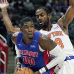 
              Detroit Pistons forward Cheick Diallo (00) is defended by New York Knicks guard Alec Burks (18) during the first half of an NBA basketball game, Wednesday, Dec. 29, 2021, in Detroit. (AP Photo/Carlos Osorio)
            