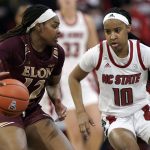 
              North Carolina State guard Aziaha James (10) guards against Elon forward Ajia James (12) during the second half of an NCAA college basketball game in Raleigh, N.C., Sunday, Dec. 5, 2021. (AP Photo/Gerry Broome)
            