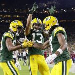 
              Green Bay Packers' Davante Adams celebrates his touchdown catch with Marquez Valdes-Scantling and Allen Lazard (13) during the first half of an NFL football game against the Chicago Bears Sunday, Dec. 12, 2021, in Green Bay, Wis. (AP Photo/Matt Ludtke)
            