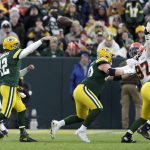 
              Green Bay Packers' Aaron Rodgers throws his 443rd career touchdown pass, during the first half of an NFL football game against the Cleveland Browns Saturday, Dec. 25, 2021, in Green Bay, Wis. The pass breaks the previous Packers record held by Brett Favre. (AP Photo/Matt Ludtke)
            