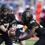 
              Appalachian State quarterback Chase Brice (7) hands off to running back Nate Noel (20) during the first half of the Boca Bowl NCAA college football game against Western Kentucky, Saturday, Dec. 18, 2021 in Boca Raton, Fla. (AP Photo/Wilfredo Lee)
            