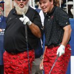 
              John Daly II, right, reacts, with his father John Daly on the first tee during the first round of the PNC Championship golf tournament Saturday, Dec. 18, 2021, in Orlando, Fla. (AP Photo/Scott Audette)
            