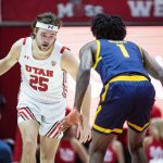 
              Utah guard Rollie Worster (25) takes the ball upcourt while guarded by California guard Joel Brown (1) during the second half of an NCAA college basketball game Sunday, Dec. 5, 2021, in Salt Lake City. (AP Photo/Isaac Hale)
            