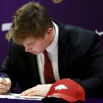 
              University of Arkansas commit Patrick Kutas Jr. signs his letter of intent during a signing day event at Christian Brothers High School in Memphis, Tenn., Wednesday, Dec. 15, 2021. (Patrick Lantrip/Daily Memphian via AP)
            