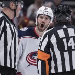 
              Columbus Blue Jackets' Boone Jenner, back, protests to referee Trevor Hanson, right, after a penalty was called against Andrew Peeke during the third period of an NHL hockey game Tuesday, Dec. 14, 2021 in Vancouver, British Columbia. (Darryl Dyck/The Canadian Press via AP)
            