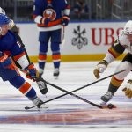 
              New York Islanders' Anthony Beauvillier (18) reaches for the puck as Vegas Golden Knights' Max Pacioretty (67) reaches for his stick during the second period of an NHL hockey game Sunday, Dec. 19, 2021, in Elmont, N.Y. (AP Photo/John Munson)
            