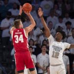
              Georgia Tech forward Khalid Moore (12) defends against Wisconsin guard Brad Davison (34) during the first half of an NCAA college basketball game Wednesday, Dec. 1, 2021, in Atlanta. (AP Photo/Hakim Wright Sr.)
            