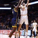
              Tennessee forward John Fulkerson (10) shoots over UNC-Greensboro forward Mohammed Abdulsalam (4) during an NCAA college basketball game Saturday, Dec. 11, 2021, in Knoxville, Tenn. (AP Photo/Wade Payne)
            