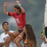 
              Luana Reis, 14, is carried atop the shoulders of friends after winning the under-18 category of a local surf tournament in Maresias beach, Sao Sebastiao, Brazil, Friday, Nov. 26, 2021. Next year Reis aims to contend for the Brazilian women’s title. (AP Photo/Andre Penner)
            
