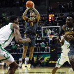 
              Baylor guard James Akinjo (11) shoots against Oregon during an NCAA college basketball game in Eugene, Ore., Saturday, Dec. 18, 2021. (AP Photo/Thomas Boyd)
            