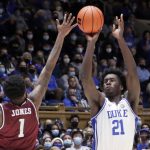 
              Duke forward A.J. Griffin (21) shoots over South Carolina State guard Cameron Jones (1) during the second half of an NCAA college basketball game Tuesday, Dec. 14, 2021, in Durham, N.C. (AP Photo/Chris Seward)
            