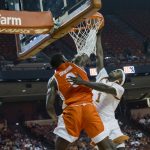 
              Texas Rio Grande Valley guard Mike Adewunmi (0) blocks the shot of Texas guard Andrew Jones (1) during the first half of an NCAA college basketball game, Friday, Dec. 3, 2021, in Austin, Texas. (AP Photo/Michael Thomas)
            