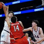 
              Texas Tech forward Marcus Santos-Silva (14) gets fouled by Gonzaga center Chet Holmgren (34) as Gonzaga forward Anton Watson, left, slaps the ball away during the second half of an NCAA college basketball game at the Jerry Colangelo Classic Saturday, Dec. 18, 2021, in Phoenix. Gonzaga won 69-55. (AP Photo/Ross D. Franklin)
            