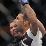 
              FILE - Charles Oliveira celebrates his victory over Will Brooks during a lightweight mixed martial arts bout at UFC 210 on April 8, 2017, in Buffalo, N.Y. Oliveira will defend his UFC lightweight title belt against Dustin Poirier in the main event of UFC 269 in Las Vegas on Saturday night, Dec. 11. (AP Photo/Jeffrey T. Barnes, File)
            