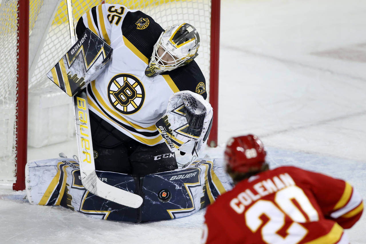 Boston Bruins goalie Linus Ullmark makes a save against Calgary Flames' Blake Coleman during the fi...